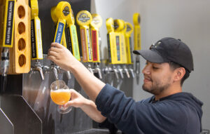 Person dispensing beer with beer tap IBW