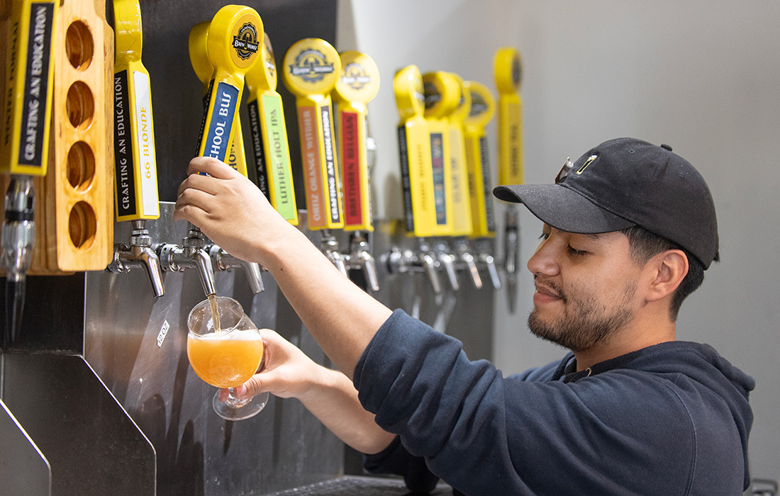 Person dispensing beer with beer tap IBW