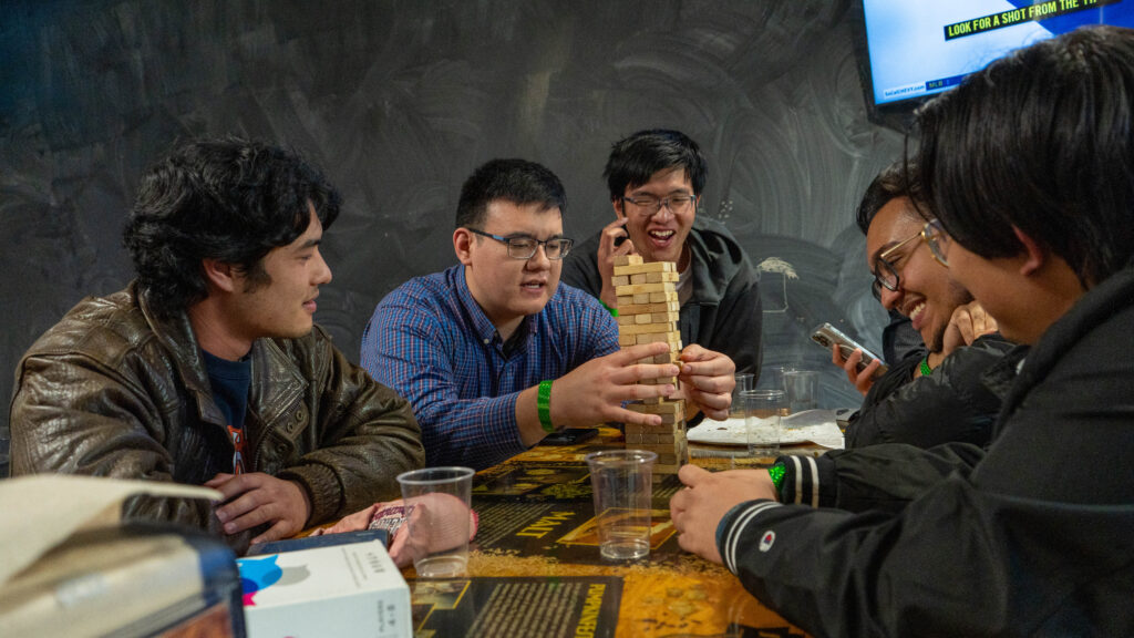 group of people playing Jenga